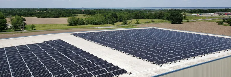 Panoramic view of solar panels covering a large commercial rooftop
