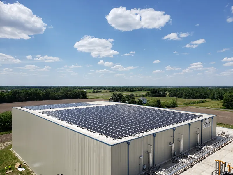 Commercial warehouse with a large solar array covering the flat roof